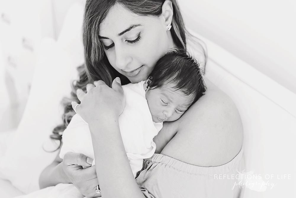 Newborn baby boy held close to mamas chest.jpg