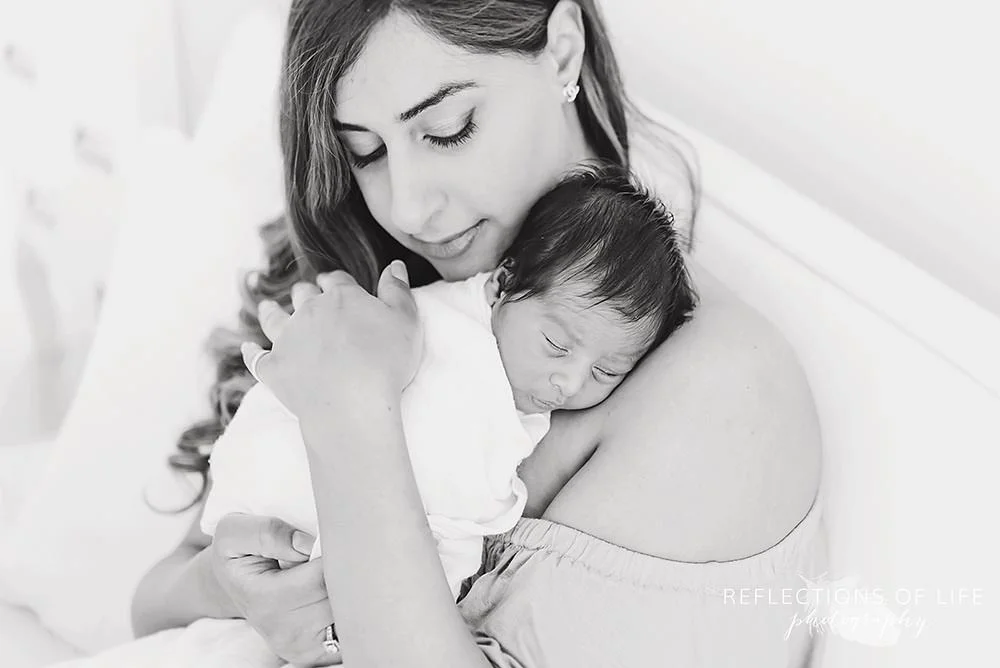 Newborn baby boy held close to mamas chest.jpg