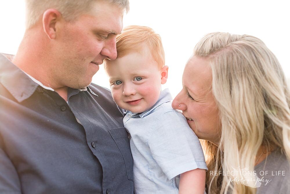 Little red haired boy smiling with his parents Grimsby Family Photos