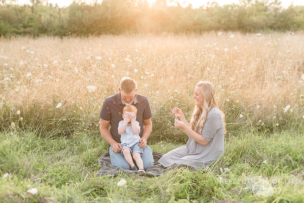 Open field photos of family blowing bubbles