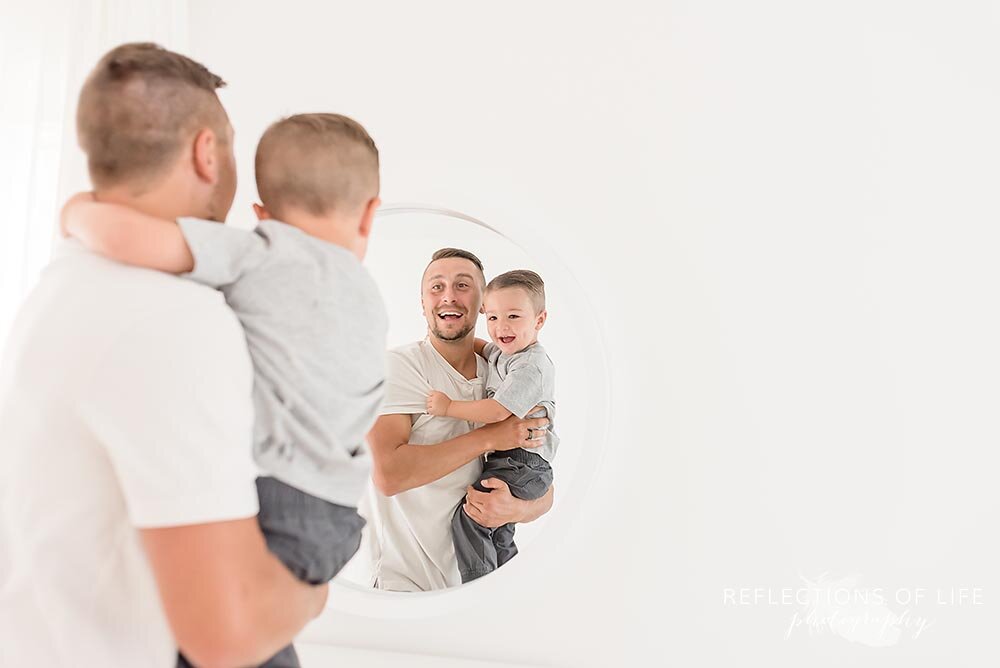 Niagara family photographer father and son reflectiion in mirror.jpg