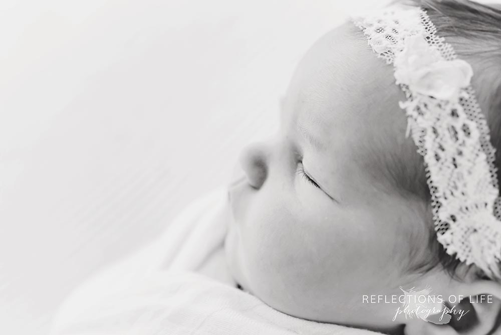 newborn baby girl side profile with headband