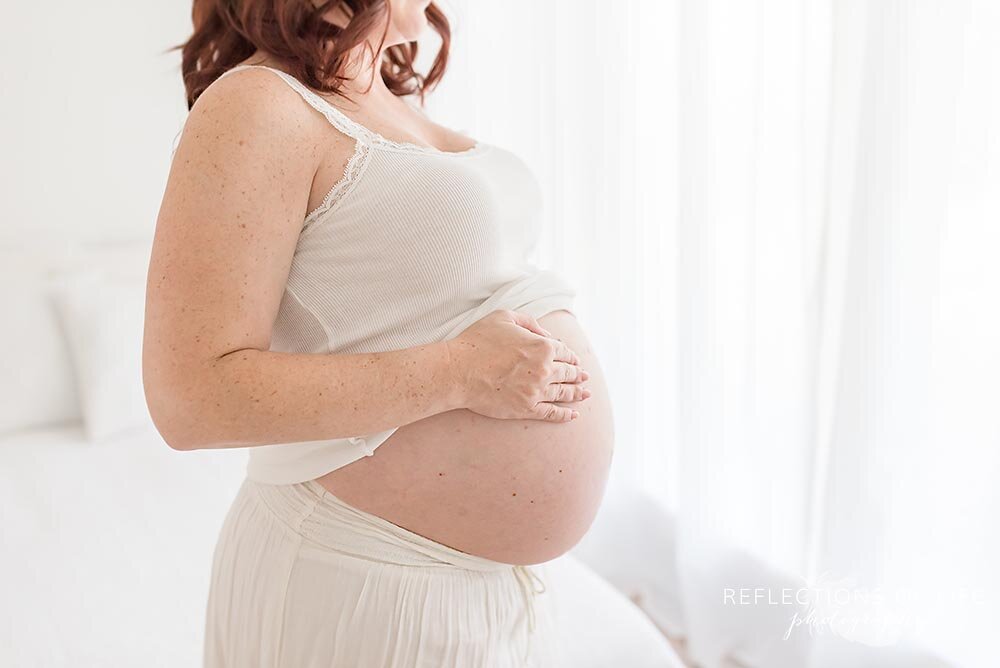 Beautiful pregnant soon-to-be mother in white studio Grimsby