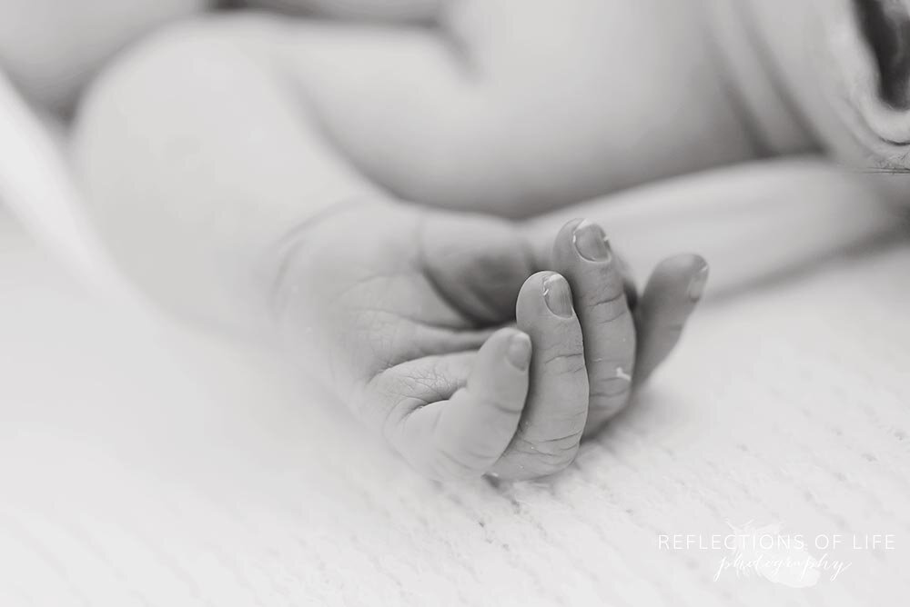 Newborn baby hand black and white close up