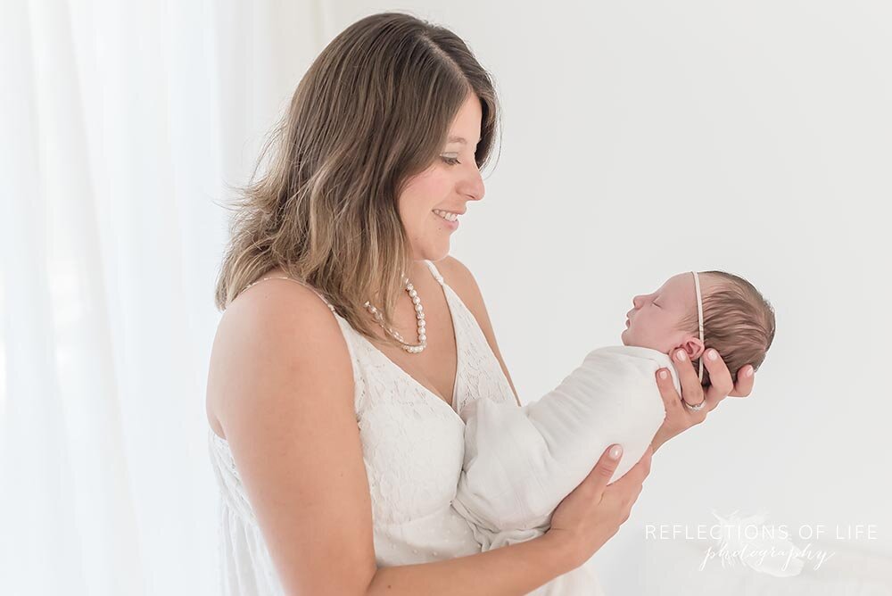 Newborn baby girl in mothers arms