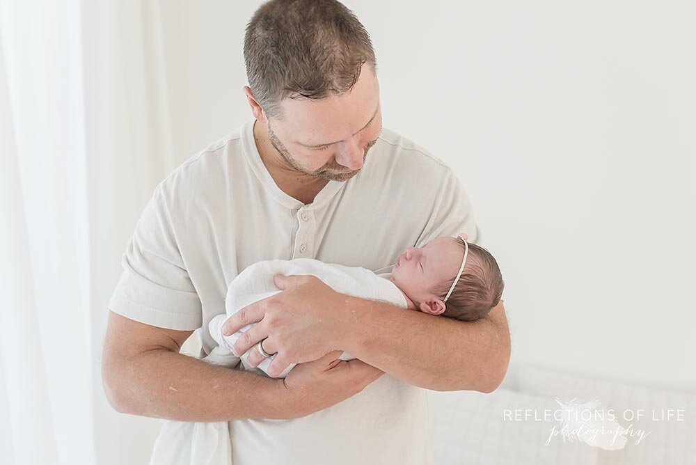 Baby girl in her daddys arms