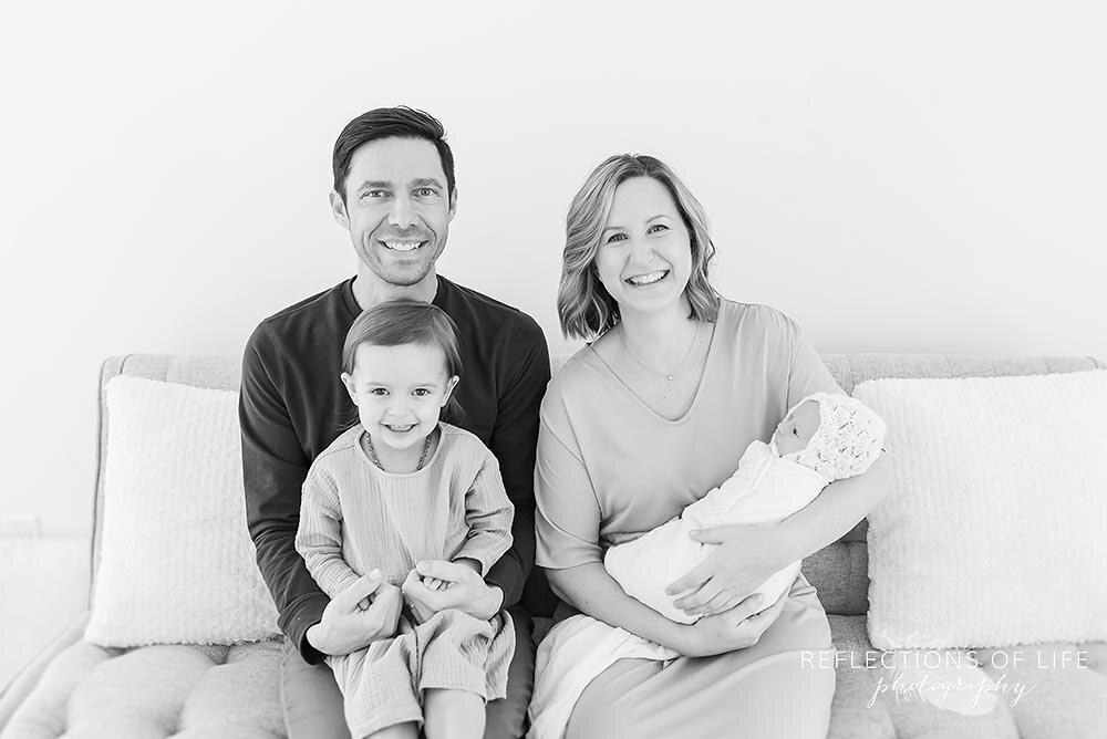 Happy Smiling Family Sitting On Couch Beamsville Ontario