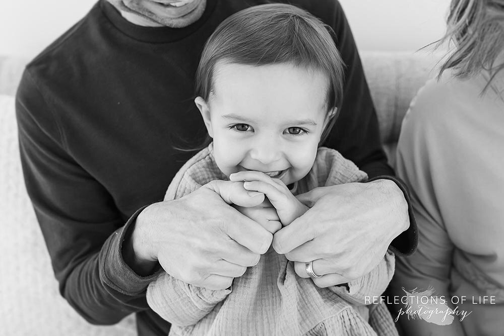 Little Girl In Fathers Arms Smiling at Camera Grimsby Ontario