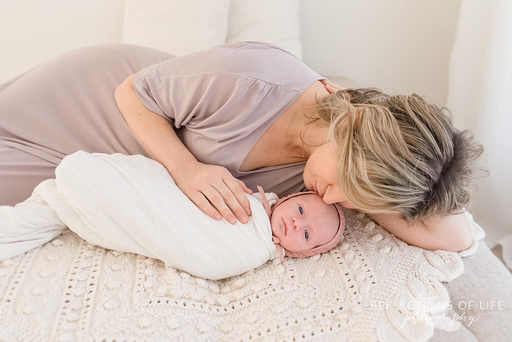 Mother Cuddling Next to Newborn Baby Stoney Creek Ontario