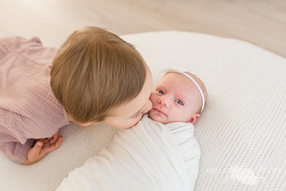 Big Sister Kissing Newborn Baby Girl Jordan Ontario