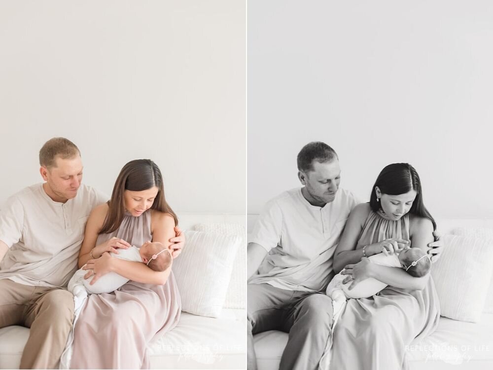 new parents hold their newborn baby girl in natural light studio Grimsby