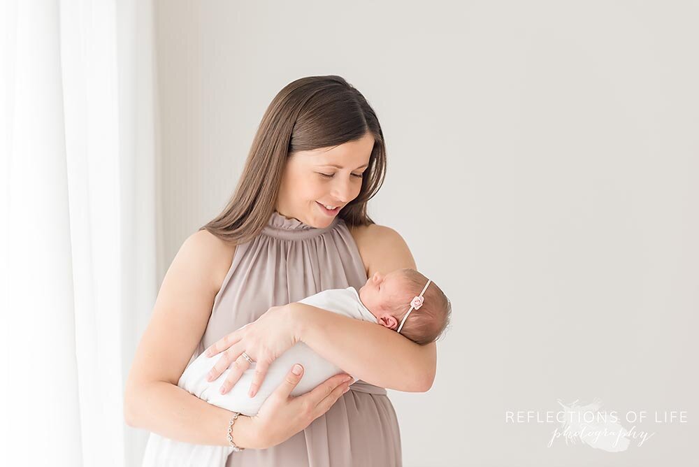 Newborn baby girl in mothers arms Grimsby photo studio