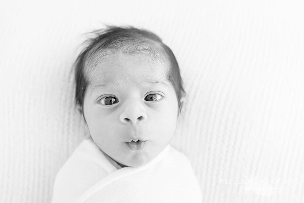 Adorable surprised face on newborn baby boy in Burlington Ontario Canada