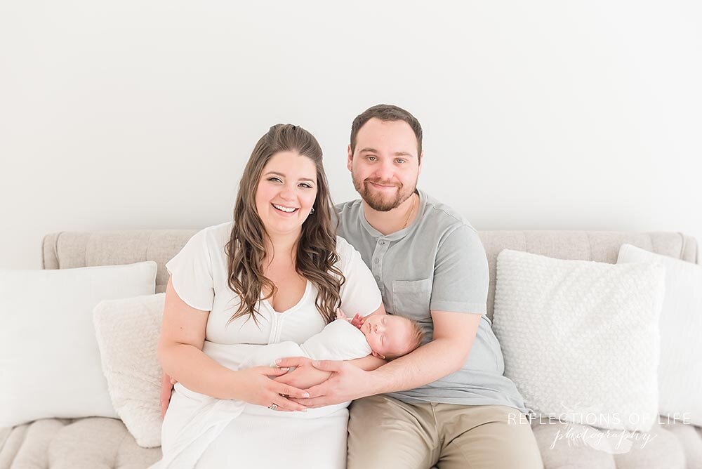 Adorable young family poses for a photo with their new baby boy in Grimsby photo studio
