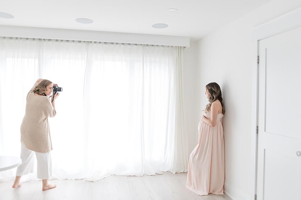 Beautiful maternity session mama dressed in light pink gown behind the scenes photo (Copy)