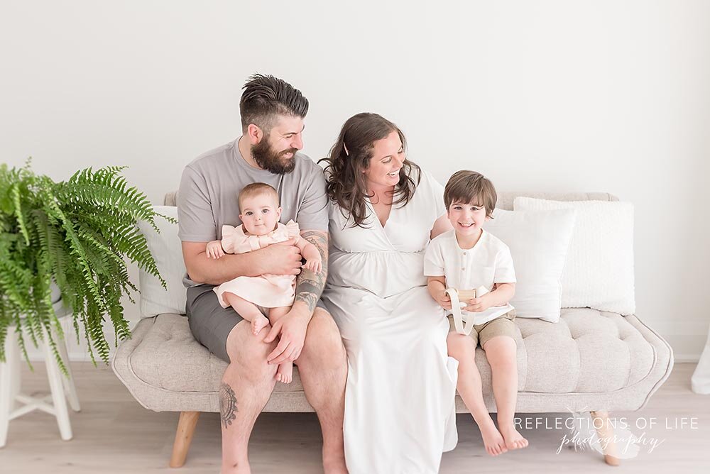 Family cuddled together on the couch Niagara photographer in Ontario Canada