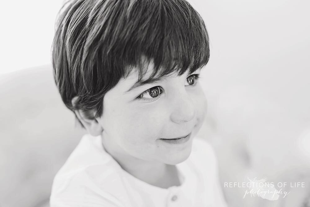 Little boy looking off the side in black and white shining eyes Niagara Ontario Canada