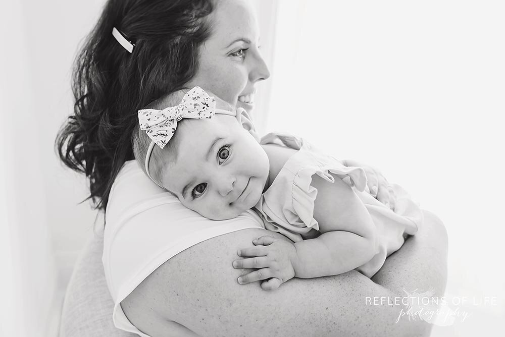 Little girl snuggling up to her mama in black and white Niagara studio photographer