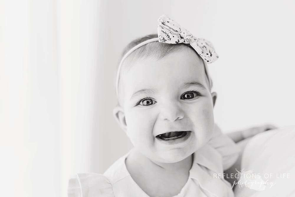 Super cute little girl laughing in black and white custom photography Niagara Ontario