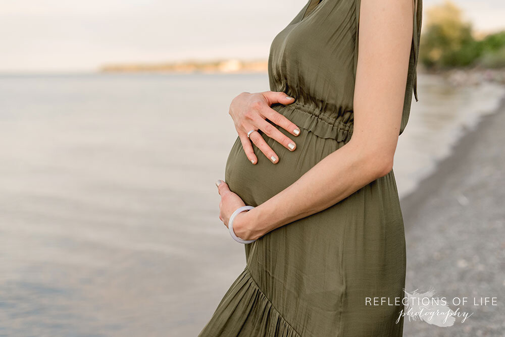 Pregnant mama in green dress by Lake Ontario Niagara Maternity Photographer