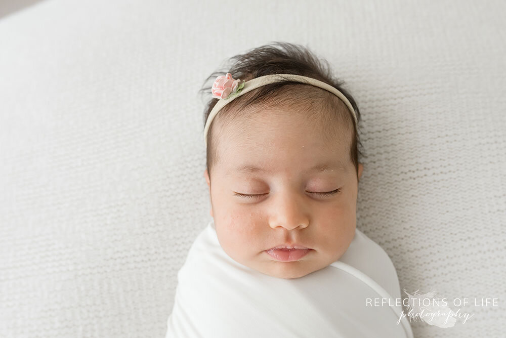 Newborn baby girl swaddled in white Niagara Region Ontario