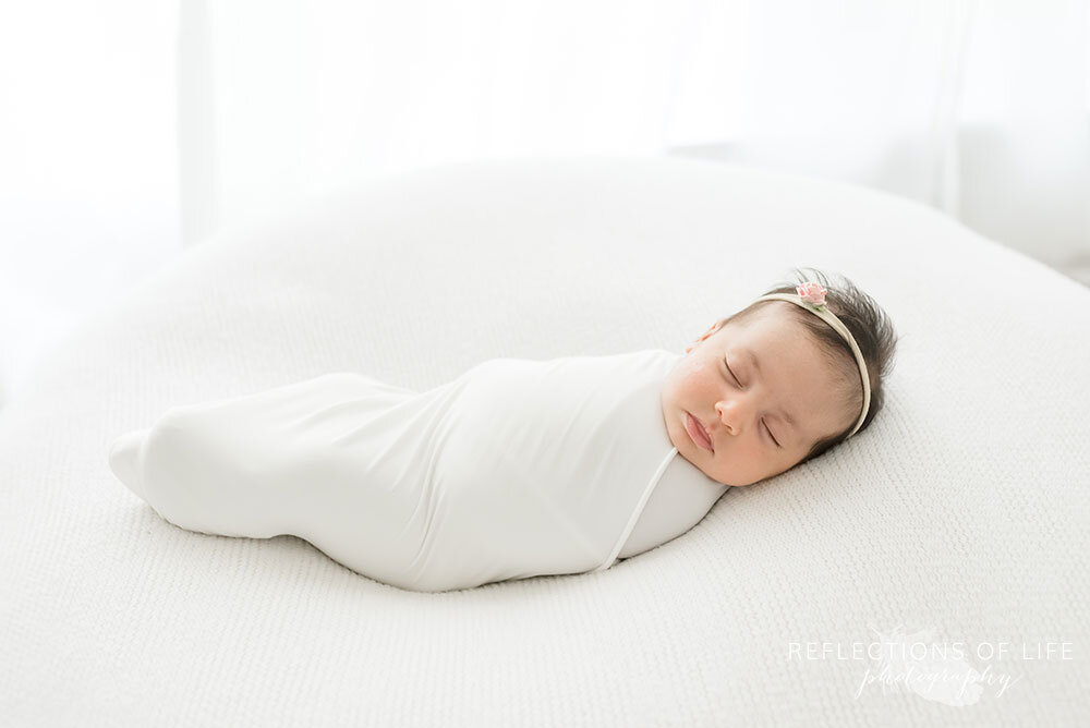 Newborn baby girl swaddled in white Grimsby Photo studio