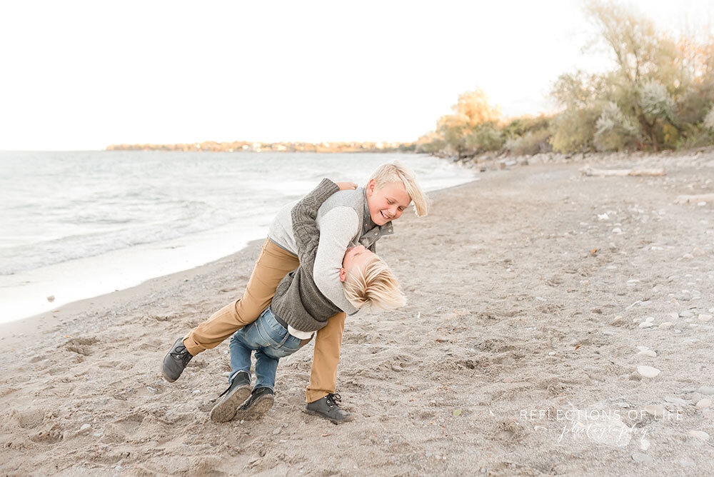 Sibling Boys playing on the beach in Grimsby Ontario