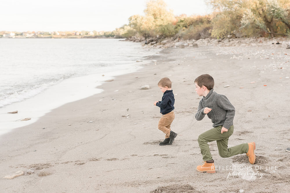 Fun family photos with little boys playing on Casablanca Beach in Niagara Region Ontario