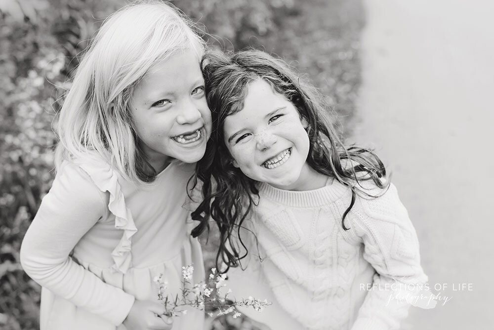 Sibling girls smiling at the camera