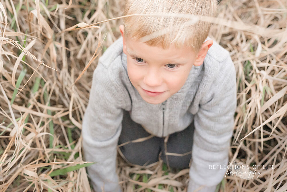 Little boy crawling through the long grass Niagara Region photo shoot