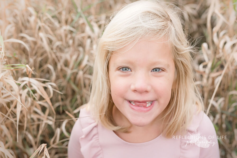 Little girl smilnig at the camera Grimsby Ontario outdoor photography session