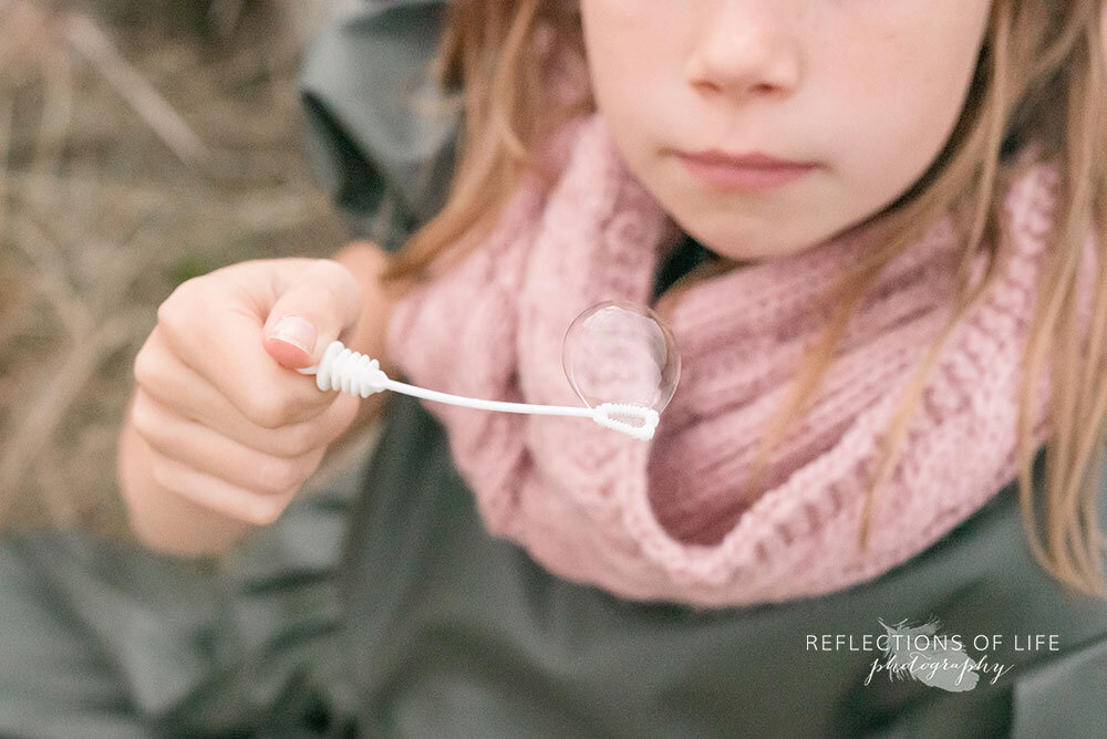 Blowing bubbles in open field in Niagara Region