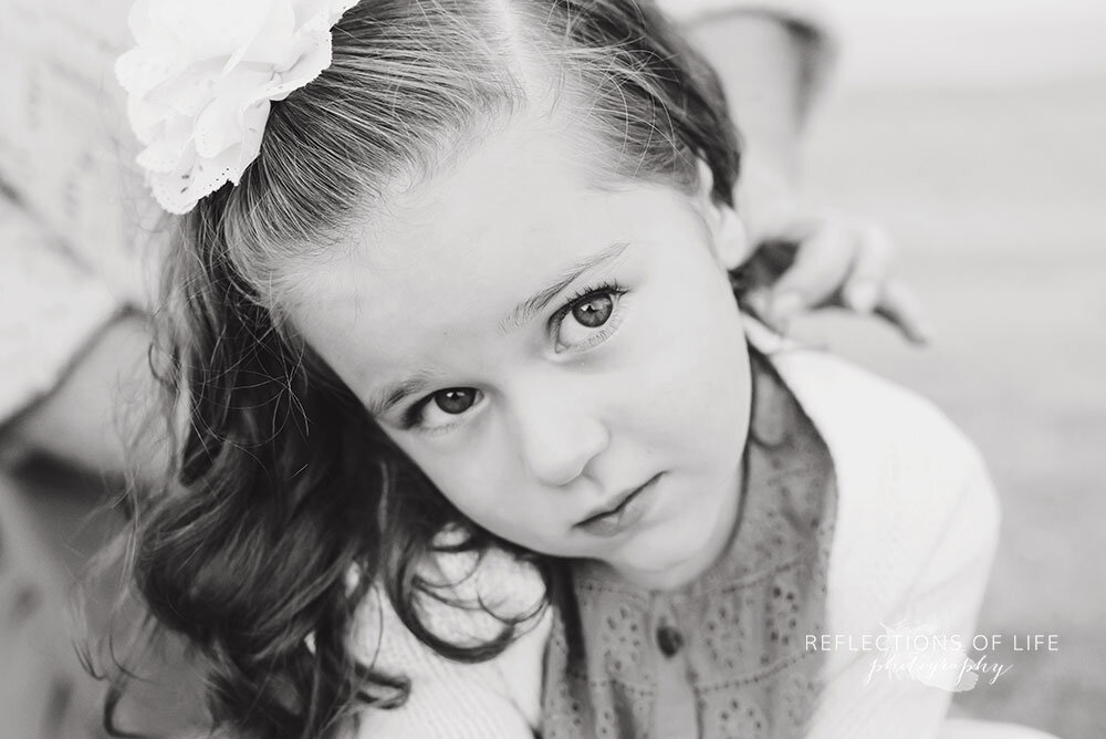 Little girl looking sad in black and white family photoshoot Grismby ON