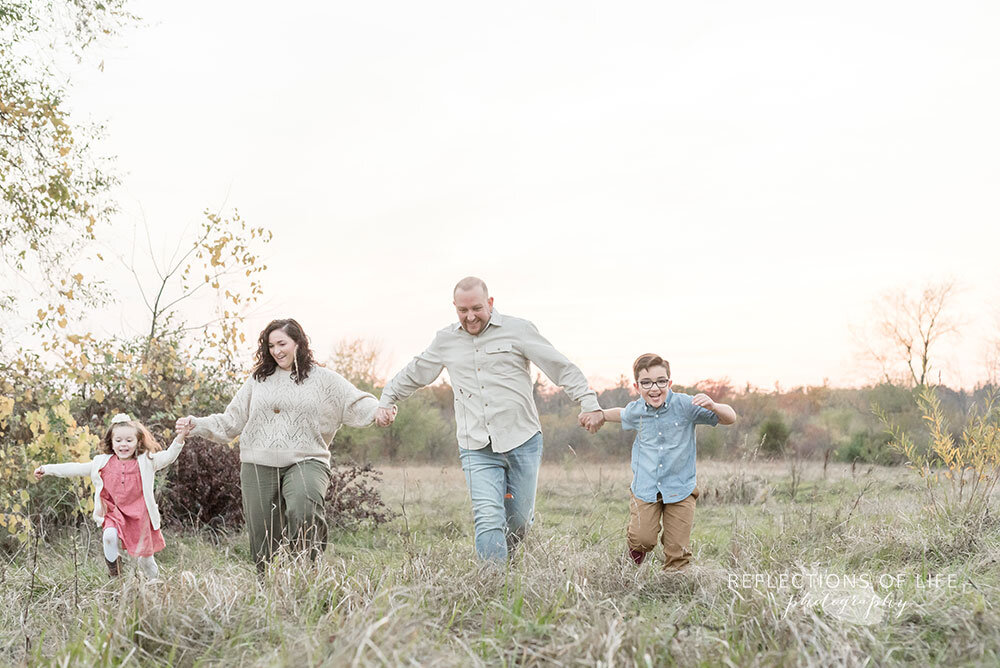 Fun and playful family photos in open field in Grimsby Ontario Canada