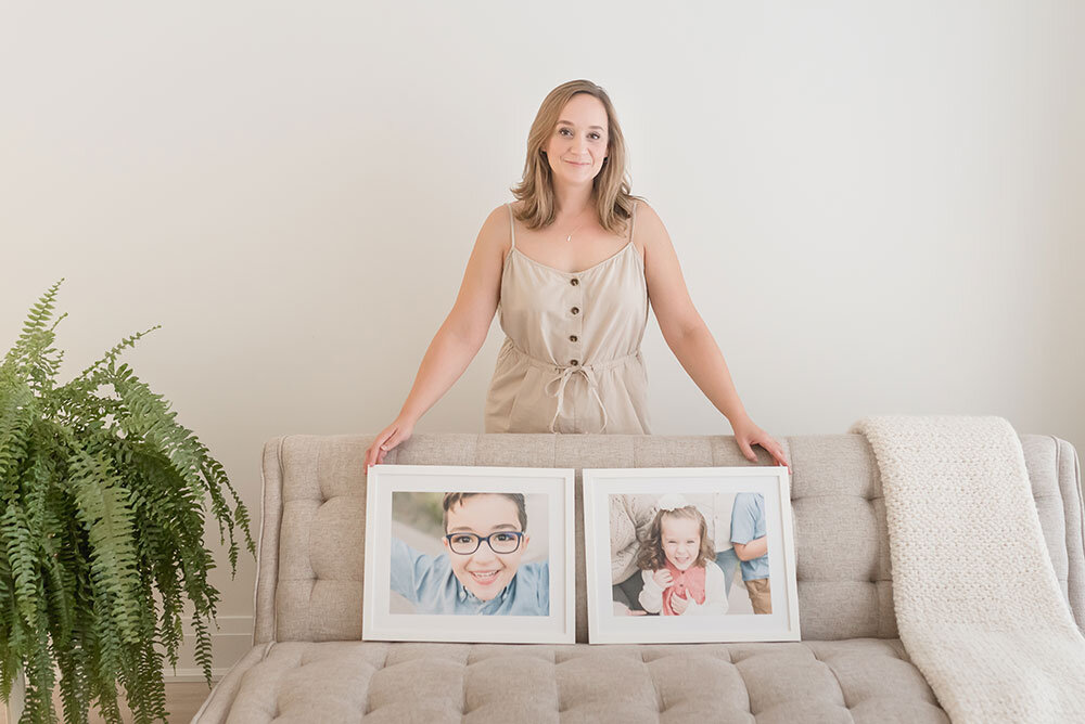 Karen Byker shows two recent child portraits framed in simple white frames Niagara Ontario professional photographer