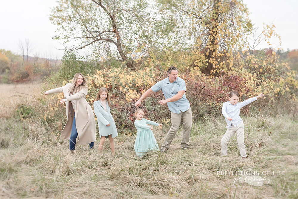Flossing dancing during fun family photoshoot Ontario Canada