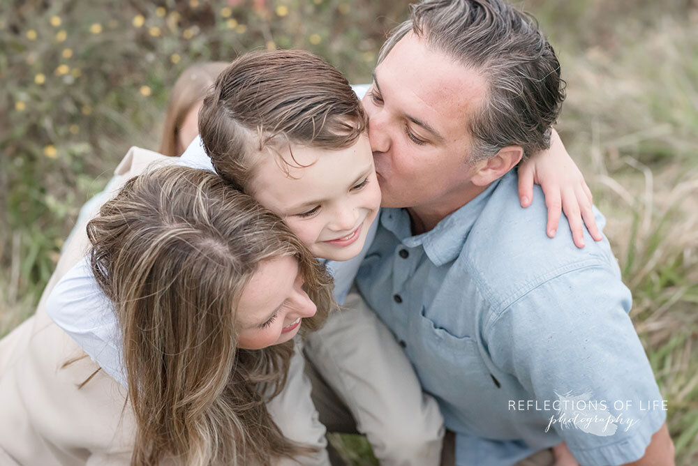 Little boy hugging his parents Niagara Region family photography