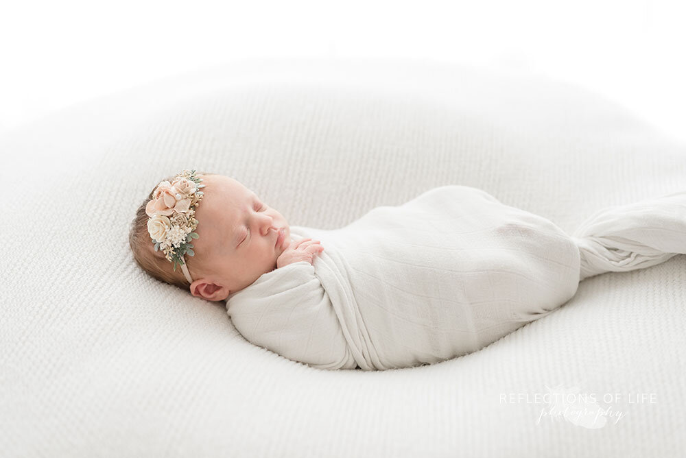 Niagara newborn photography with floral headband by Sweet Nest Boutique studio baby girl portraits