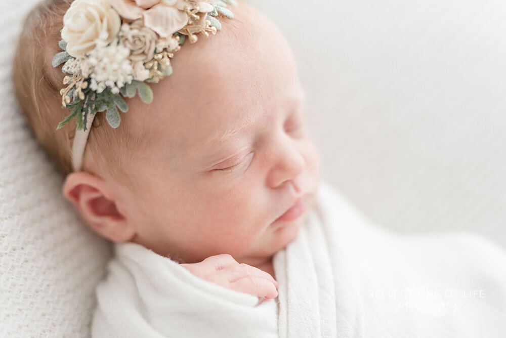 Newborn baby girl photography with floral headband by Sweet Nest Boutique in Niagara Region Ontario
