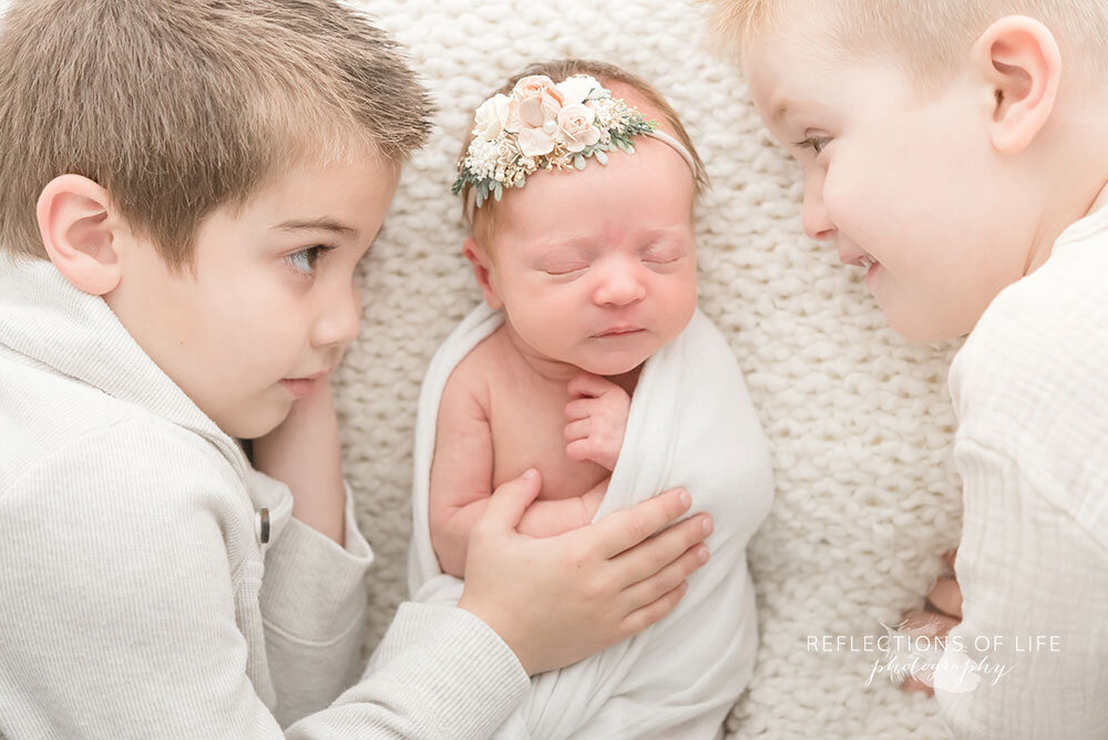Newborn and sibling photography Niagara Region Ontario Canada with floral headband by Sweet Nest Boutique
