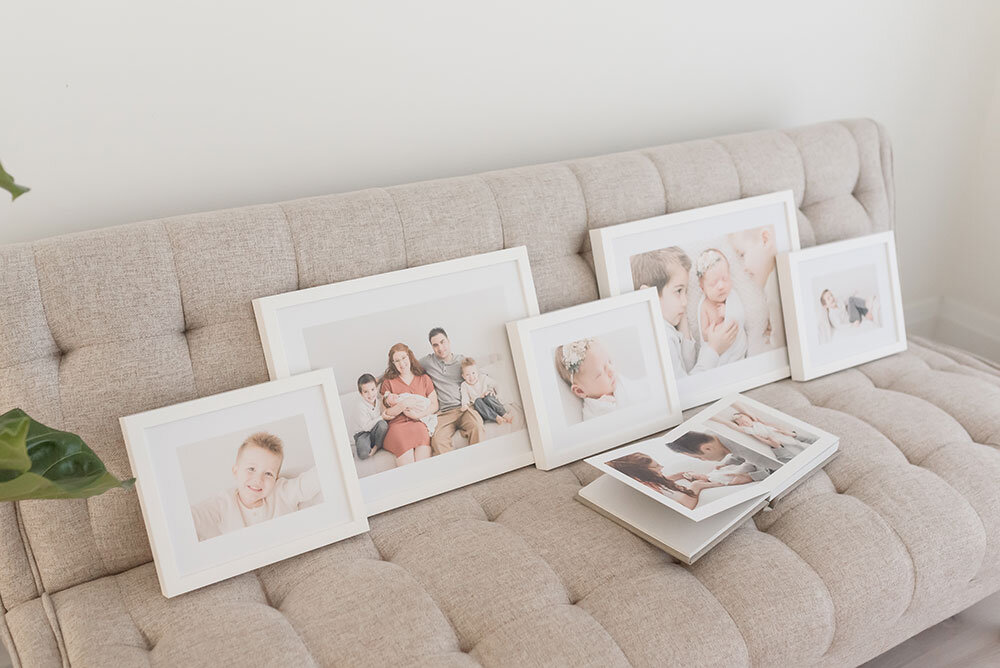 White custom frames on deep matte artwork by Grimsby Newborn and family photographer