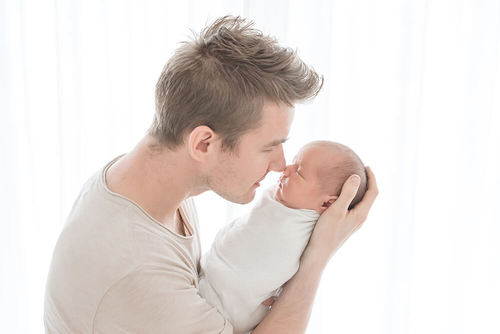 Daddy rubs noses with his newborn son in Grimsby Photography Studio Niagara Ontario