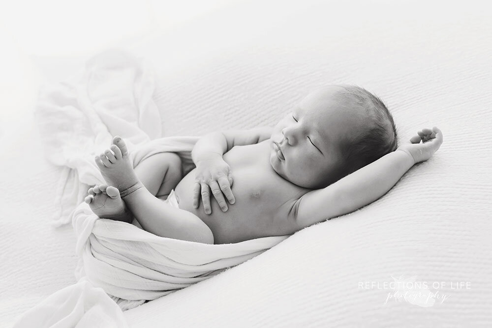relaxed and sleepy newborn baby boy photography in Niagara Region photo studio