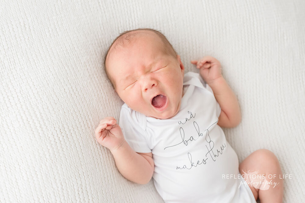 Adorable photo os newborn baby boy yawning Niagara Region Professional Photo Studio