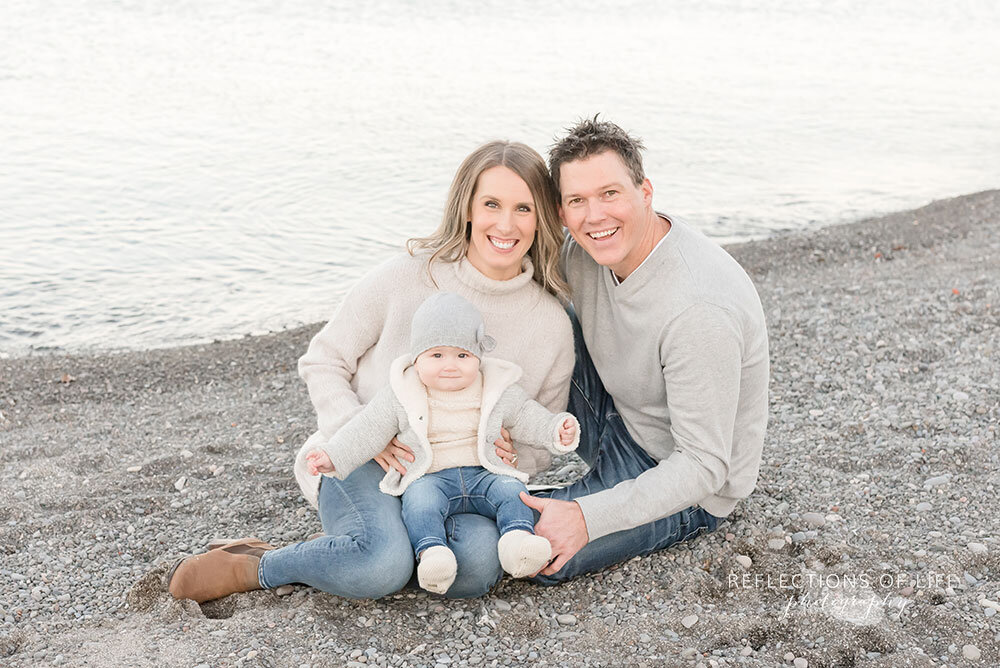 Sitting on the beach during fall family session in Grimsby Ontario Canada