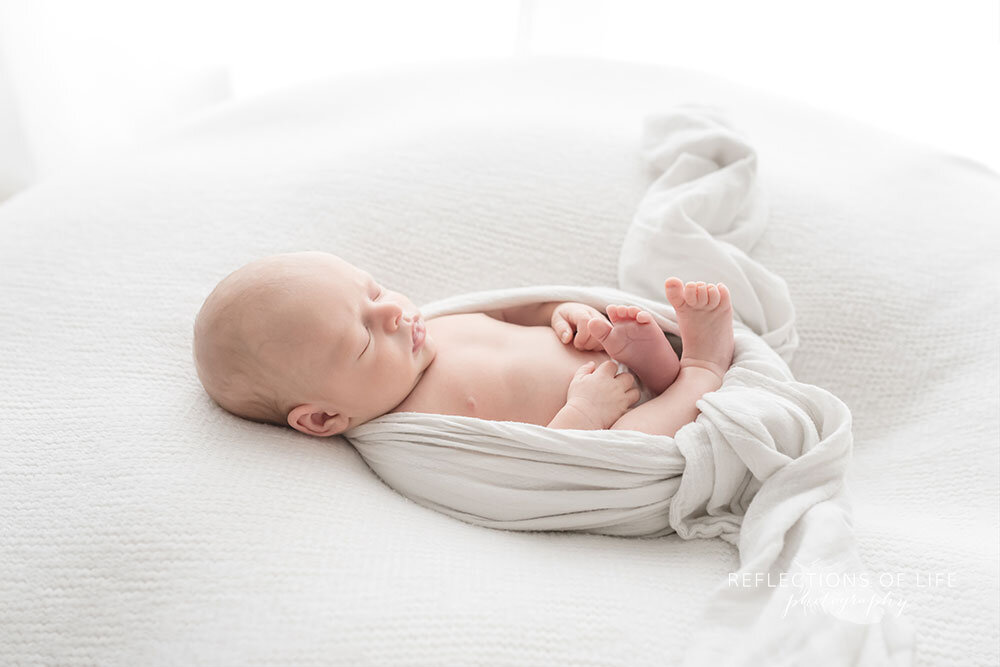 Niagara-newborn-baby-phtoography-of-little-baby-boy-wrapped-in-white