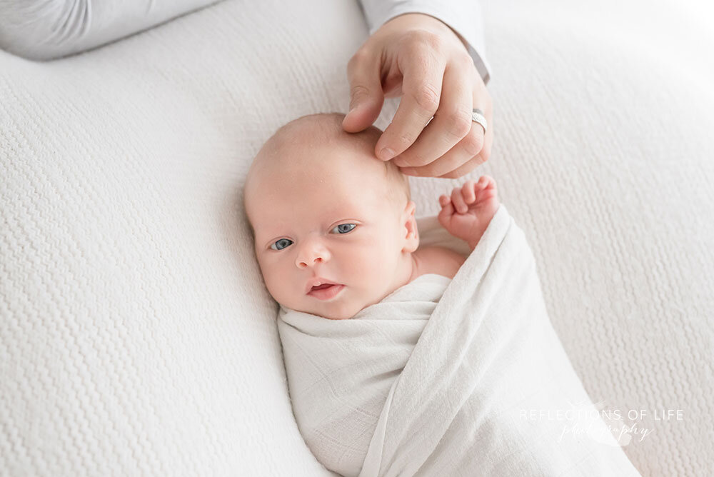 Newborn-baby-wrapped-in-white-swaddle-blanket-Grimsby-newborn-photography