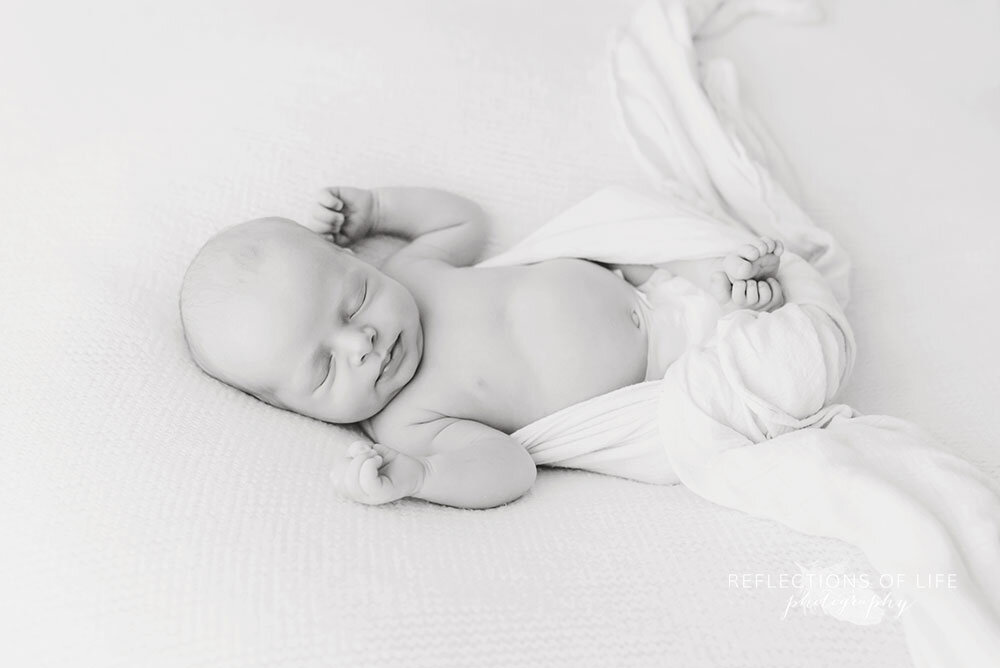 Niagara Region newborn baby photography swaddled in white