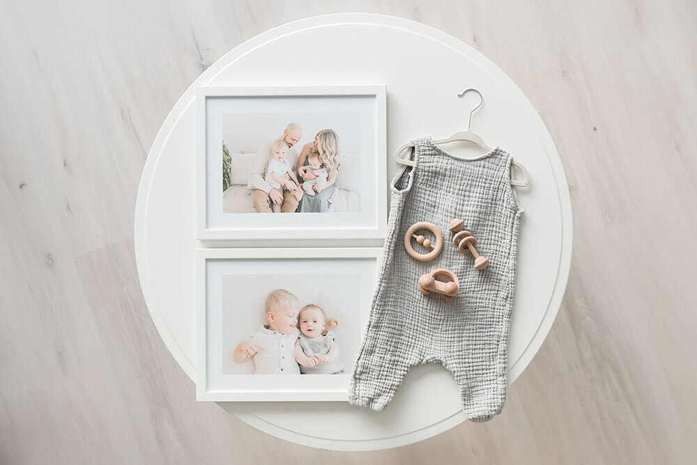 Flat lay family photo prints framed with baby props