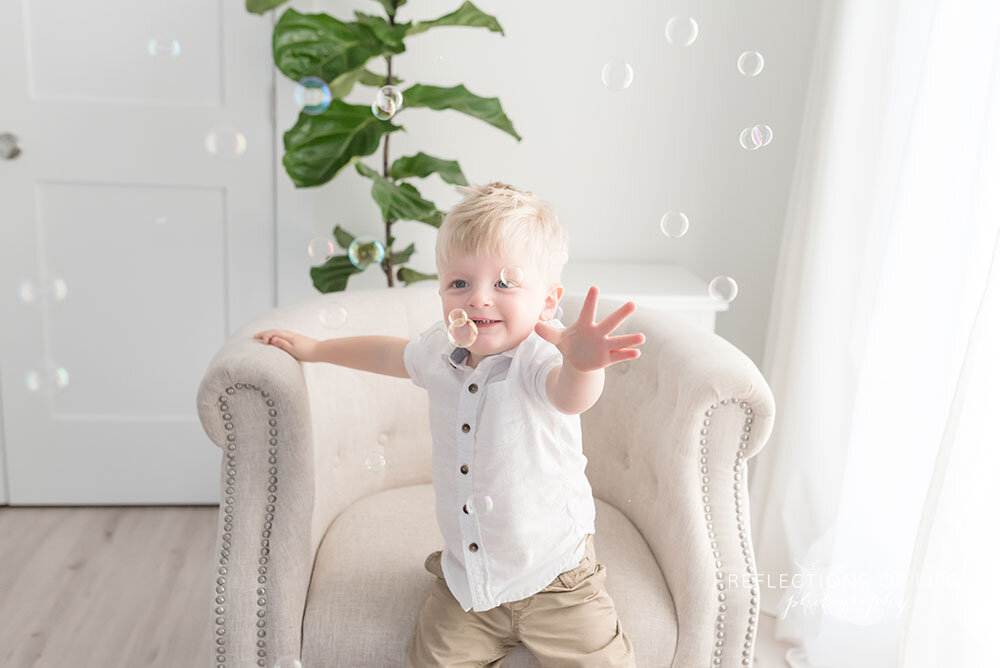 Boy chases bubbles for niagara family photography 